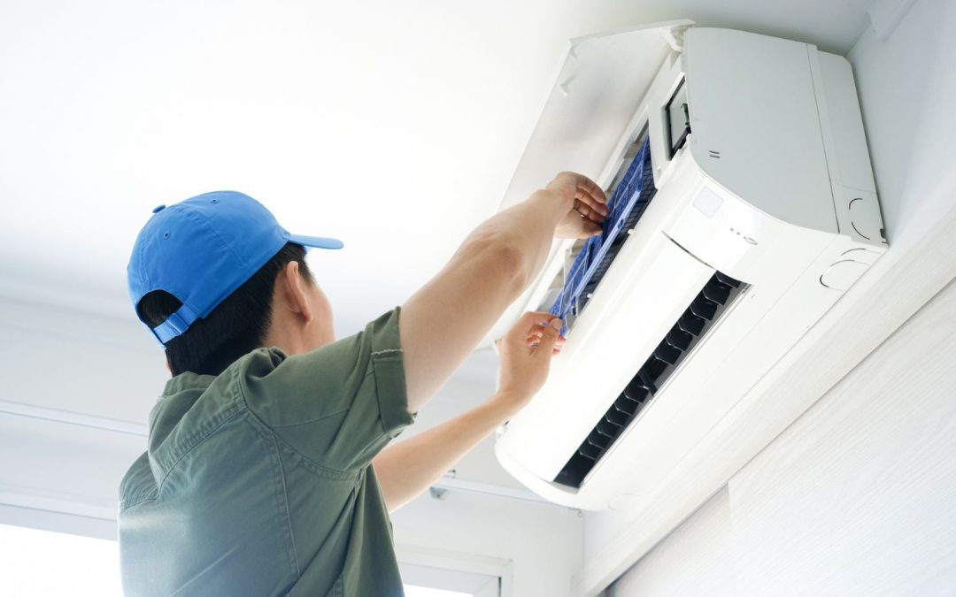 HVAC technician servicing a ductless mini split in Laguna Beach