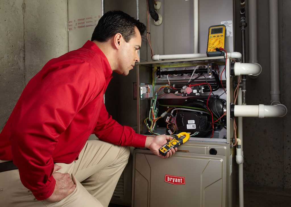 Heating technician diagnosing a furnace repair in Laguna Beach