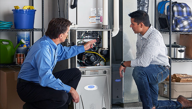 Technician evaluating a furnace for repair or replacement in Laguna Beach