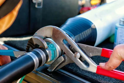 Technician repairing an industrial pipe connection in Laguna Beach