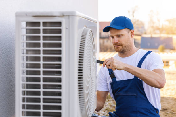 HVAC technician servicing an outdoor air conditioner in Laguna Beach