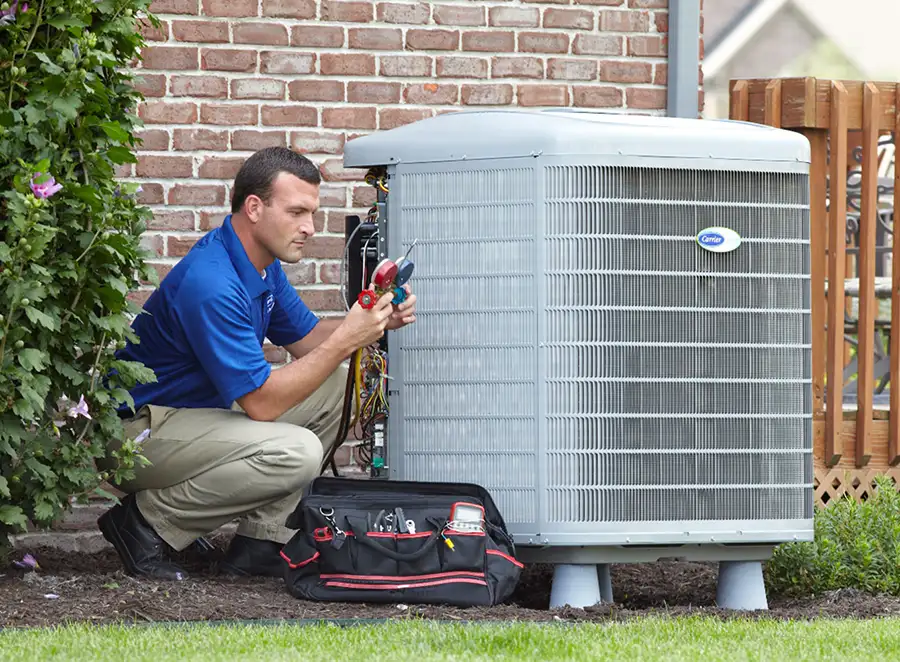 HVAC technician inspecting an outdoor AC unit in Laguna Beach