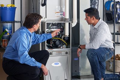 Furnace Repair or Replacement Laguna Beach Technician evaluating a furnace for repair or replacement in Laguna Beach