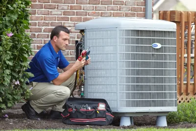 Outdoor AC Unit Inspection Laguna Beach HVAC technician inspecting an outdoor AC unit in Laguna Beach